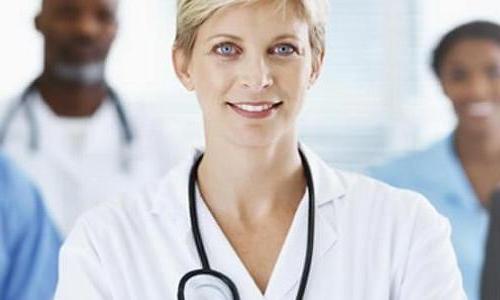 Nurse executive smiling with medical team in background