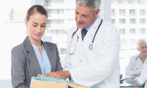 Nursing Executive Reviewing Charts with Physician